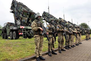 Soldiers stand ahead of Patriot anti-missile defence systems during Ukrainian president Volodymyr Zelensky's visit to a military training area